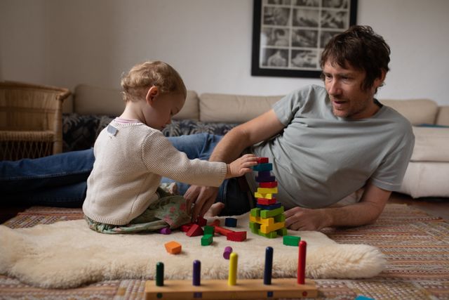 Father playing with his child on the floor at home - Download Free Stock Photos Pikwizard.com