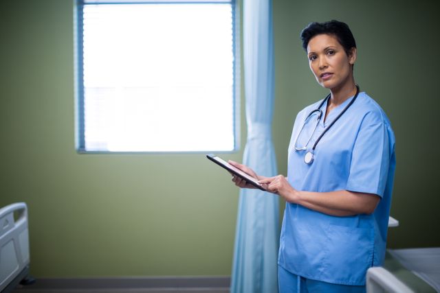 Portrait of female nurse using digital tablet in ward - Download Free Stock Photos Pikwizard.com