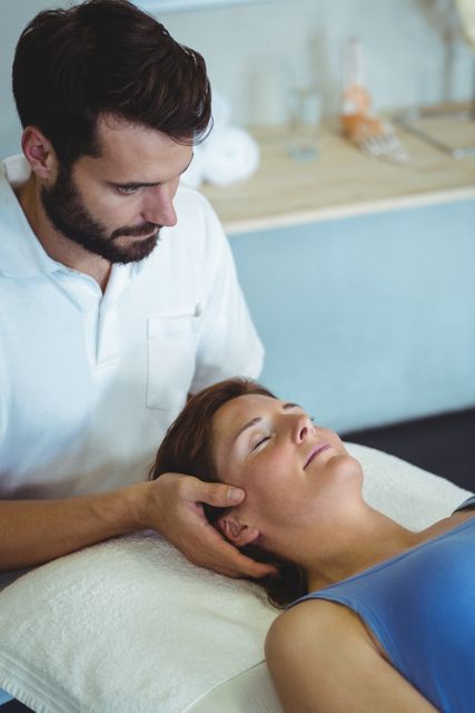 Physiotherapist giving head massage to a woman - Download Free Stock Photos Pikwizard.com