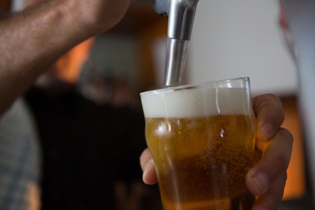 Brewer filling beer in beer glass from beer pump in bar - Download Free Stock Photos Pikwizard.com