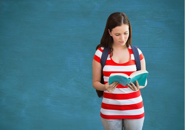 Student holding a book against blue background - Download Free Stock Photos Pikwizard.com