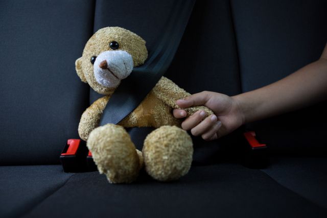 Teenage girl sitting with teddy bear in the back seat of car - Download Free Stock Photos Pikwizard.com