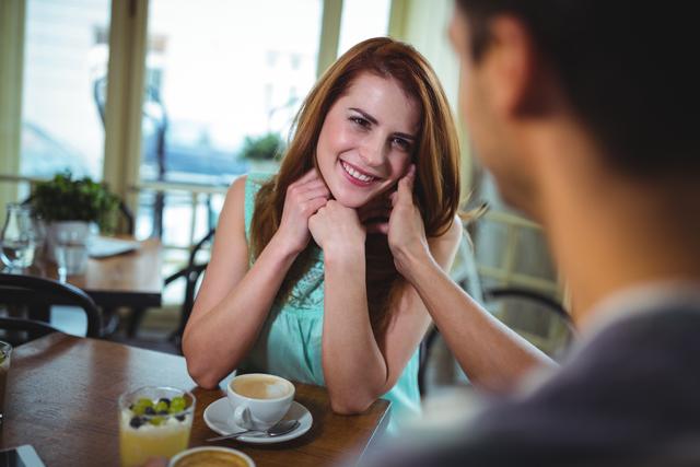 Couple interacting while having coffee - Download Free Stock Photos Pikwizard.com