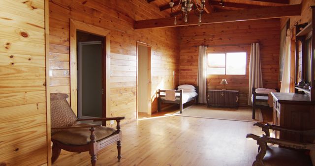 General view of bedroom with beds and armchairs in log cabin, slow motion. Interior, design and countryside concept.