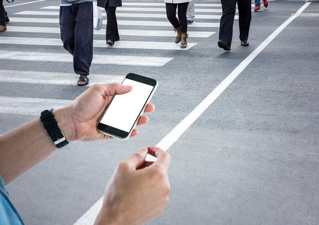 Digital composite of Men hands with phone in a crosswalk
