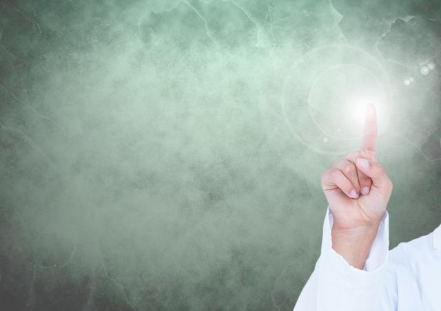 Doctors hand touching a lens flare against green background - Download Free Stock Photos Pikwizard.com