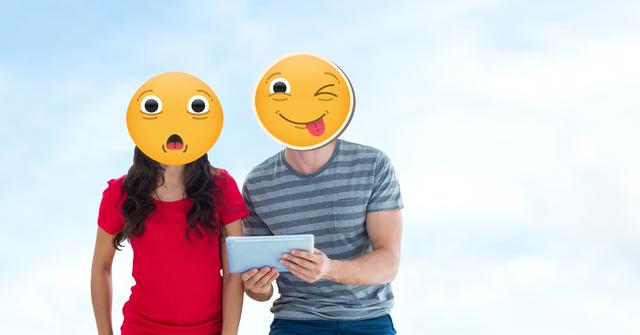 Couple with naughty and shocked emojis on faces using tablet PC - Download Free Stock Photos Pikwizard.com