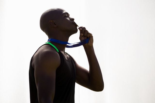Athlete kissing his gold medal - Download Free Stock Photos Pikwizard.com