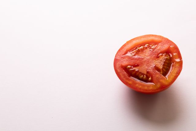 Directly above view of fresh tomato halves by copy space on white background - Download Free Stock Photos Pikwizard.com