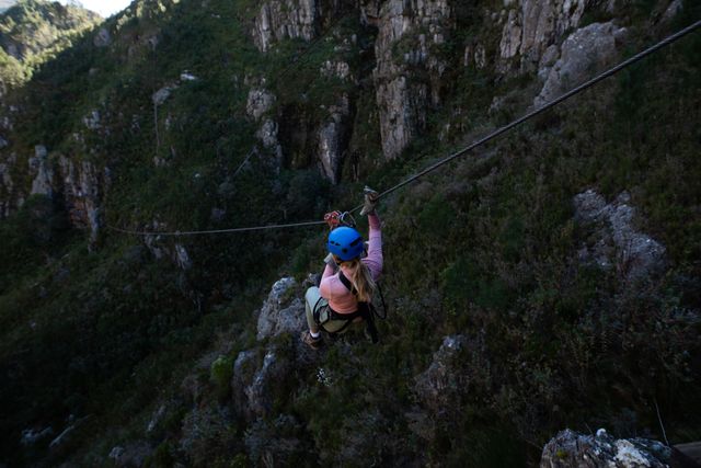 Caucasian woman zip lining while enjoying time in nature - Download Free Stock Photos Pikwizard.com