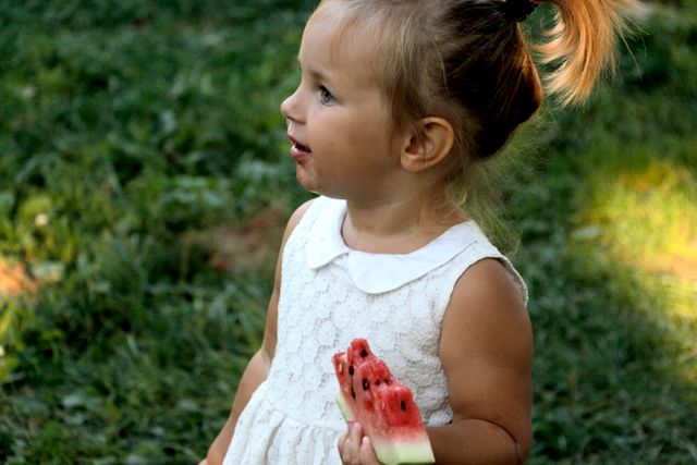 a little girl holding a watermelon - Download Free Stock Photos Pikwizard.com