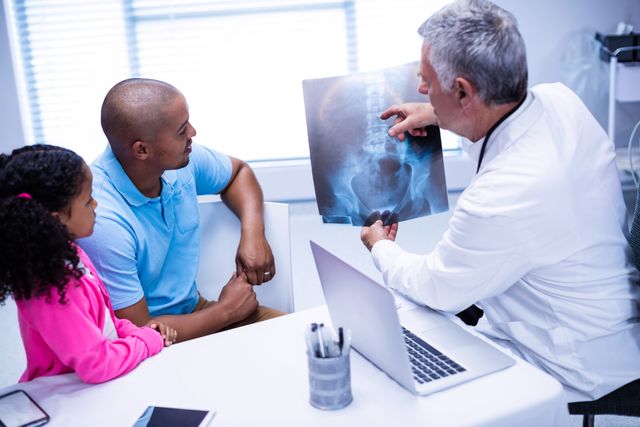 Doctor discussing x-ray report with patient - Download Free Stock Photos Pikwizard.com