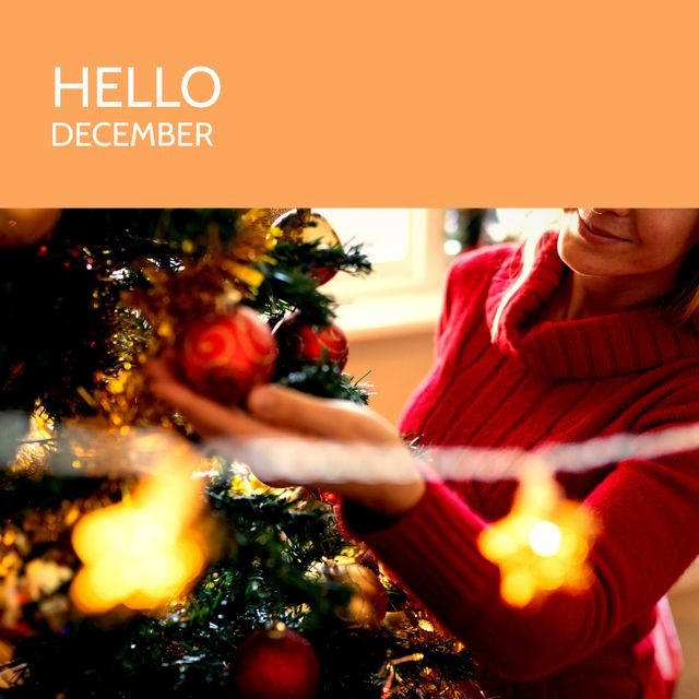 Composition of hello december text over caucasian woman with christmas tree. Winter and celebration concept digitally generated image.