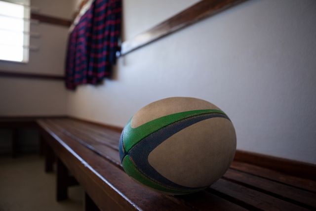 Close-up of rugby ball on bench - Download Free Stock Photos Pikwizard.com