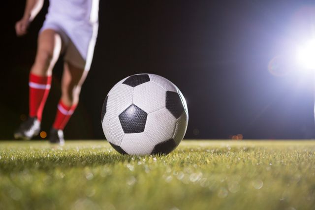 Low section of soccer player and ball on field - Download Free Stock Photos Pikwizard.com