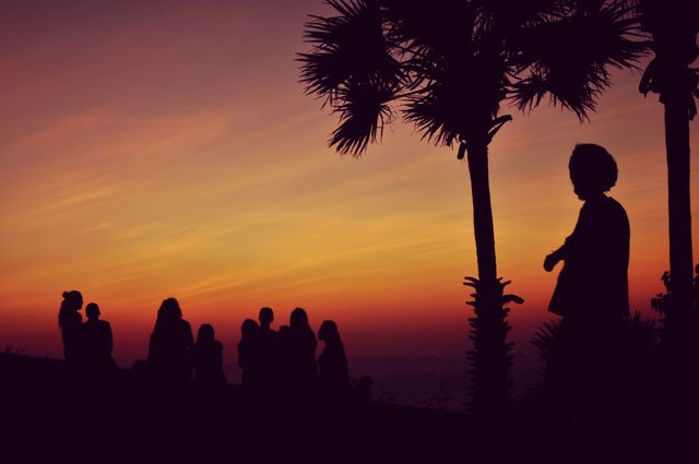 Silhouette of People Standing Under Orange Sky - Download Free Stock Photos Pikwizard.com