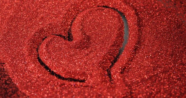 Person drawing shape of heart on red glitter - Download Free Stock Photos Pikwizard.com
