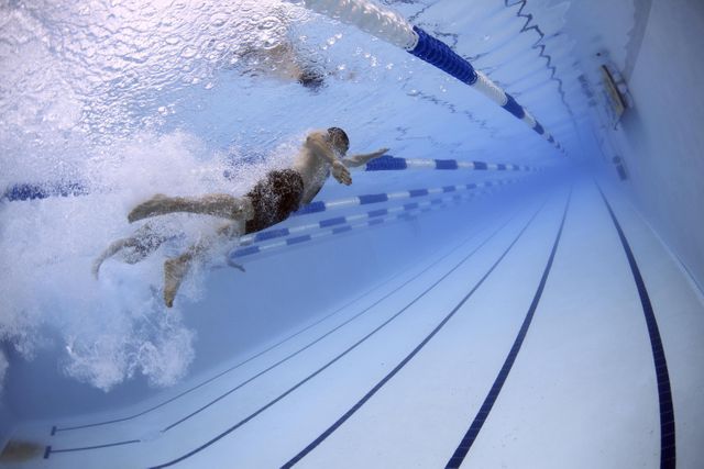 a swimmer in a pool - Download Free Stock Photos Pikwizard.com