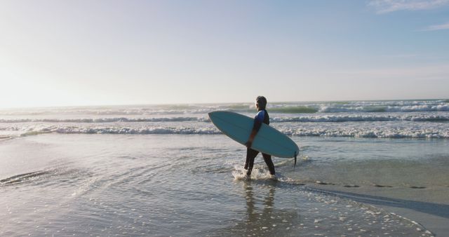 Senior african american woman walking with a surfboard at the beach - Download Free Stock Photos Pikwizard.com