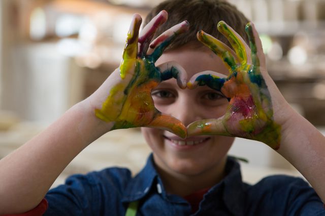 Boy gesturing with painted hands - Download Free Stock Photos Pikwizard.com