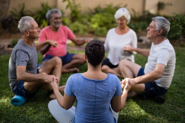 Trainer holding hands and meditating with senior men and women- Download Free Stock Photos Pikwizard.com