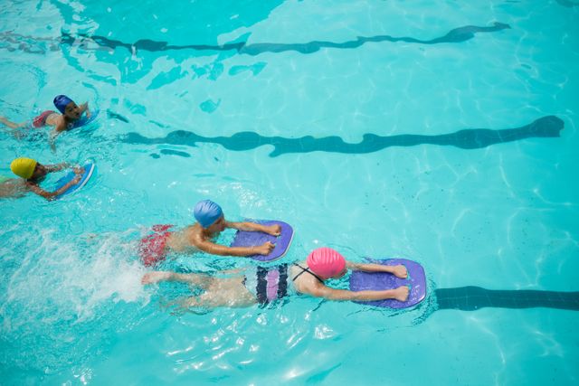Girls and boys using kickboard while swimming in pool - Download Free Stock Photos Pikwizard.com
