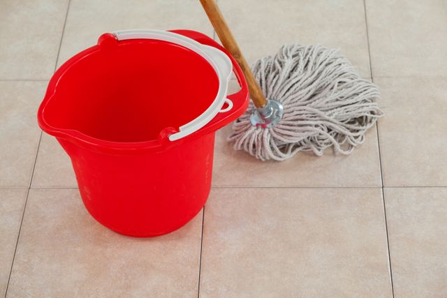 Empty bucket and mop on tile floor - Download Free Stock Photos Pikwizard.com