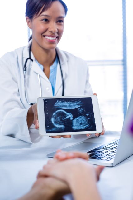 Doctor showing babies ultrasound scan on digital tablet - Download Free Stock Photos Pikwizard.com