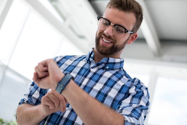 Male executive using smartwatch in the office