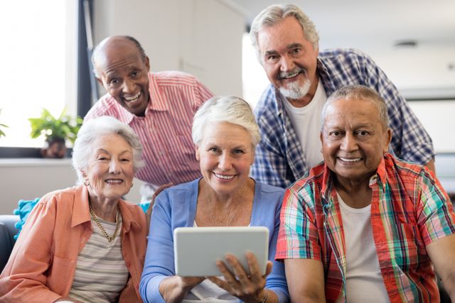 Smiling senior people with digital tablet in nursing home