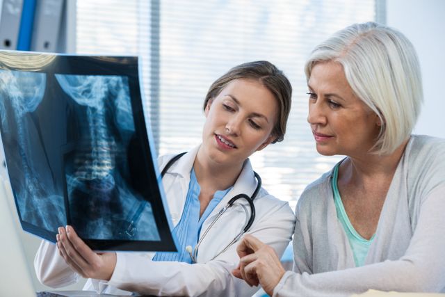 Female doctor explaining x-ray report to patient - Download Free Stock Photos Pikwizard.com