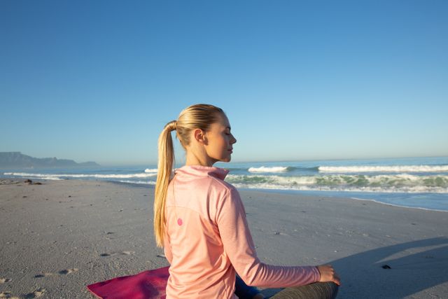 Woman practicing yoga on the beach - Download Free Stock Photos Pikwizard.com