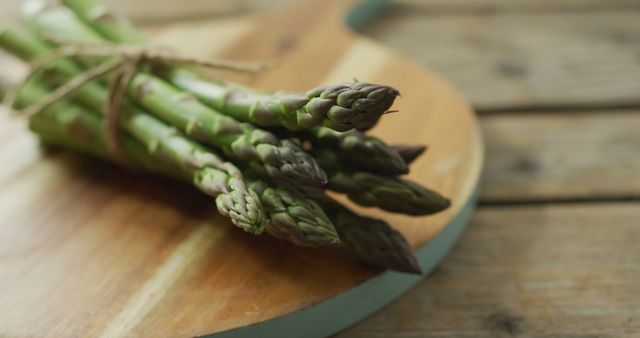 Image of close up of fresh asparagus bundles on wooden board background - Download Free Stock Photos Pikwizard.com