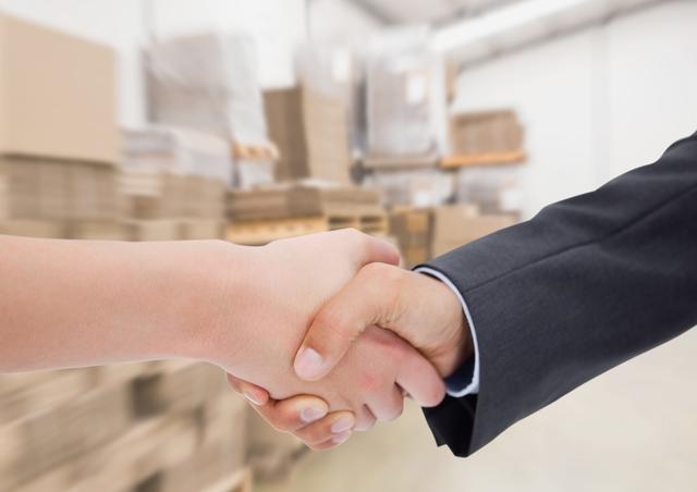 Business executives shaking hands against warehouse in background - Download Free Stock Photos Pikwizard.com