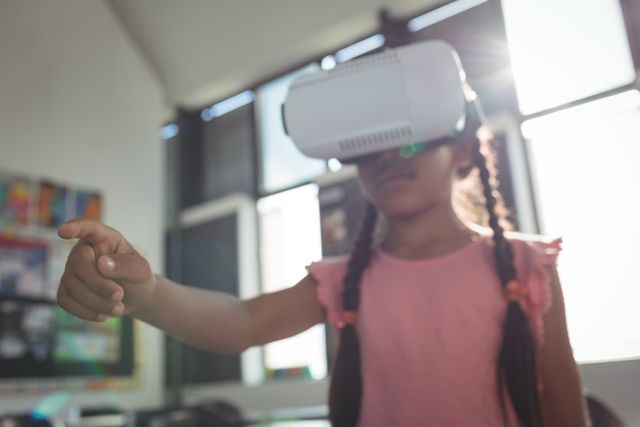 Girl wearing virtual reality simulator in classroom - Download Free Stock Photos Pikwizard.com