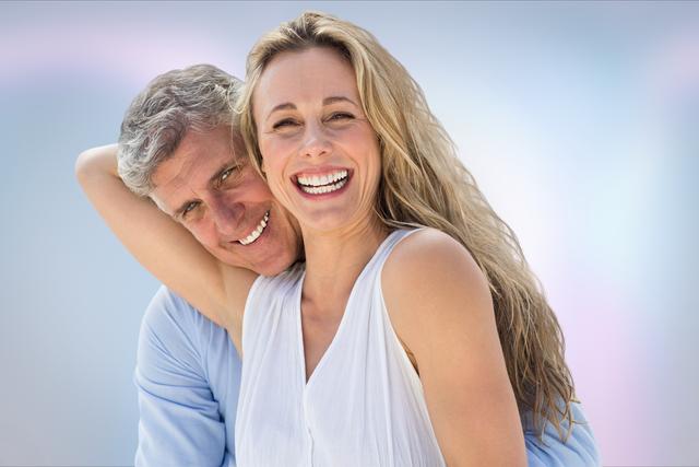 Portrait of smiling senior couple against blue background - Download Free Stock Photos Pikwizard.com
