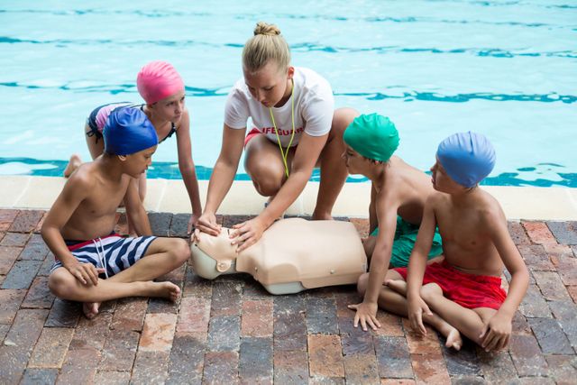 lifeguard giving rescue training to children at poolside - Download Free Stock Photos Pikwizard.com
