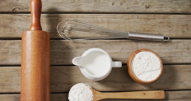 Image of baking ingredients and tools lying on wooden surface. baking, food preparing, taste and flavour concept.