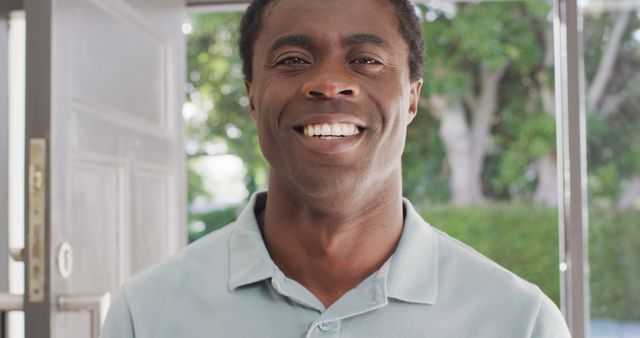 Portrait of happy african american man at door - Download Free Stock Photos Pikwizard.com