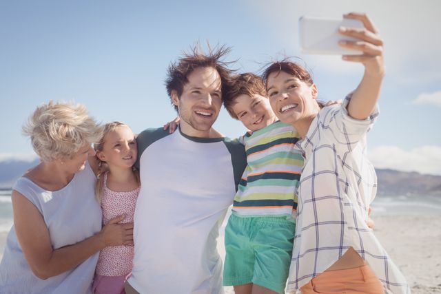 Happy multi-generation family taking selfie at beach - Download Free Stock Photos Pikwizard.com
