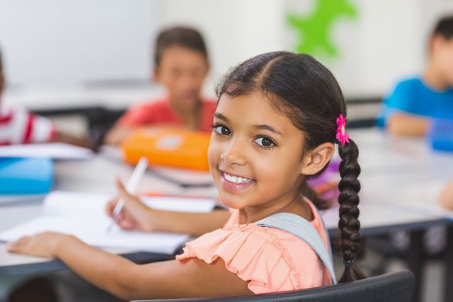 Portrait of happy schoolgirl in classroom at school