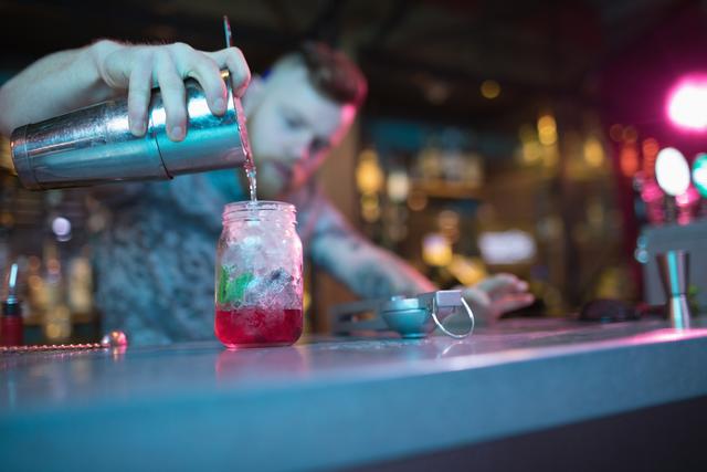 Bartender preparing cocktail at counter - Download Free Stock Photos Pikwizard.com