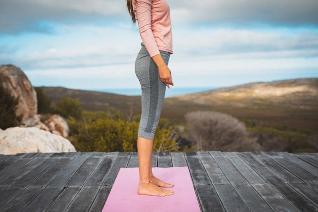 Mid section of caucasian woman standing on yoga mat on a wooden floor in the mountains - Download Free Stock Photos Pikwizard.com