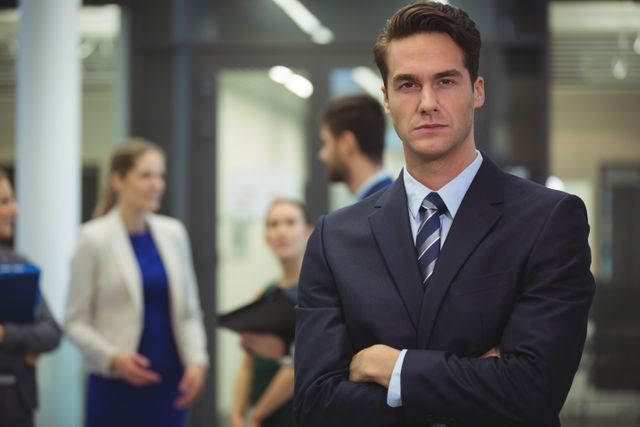 Portrait of businessman standing with arms crossed in the office