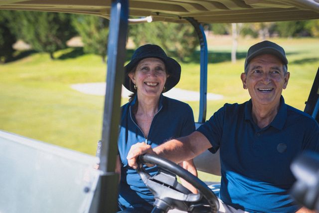 Happy caucasian senior couple driving in golf buggy at a golf course and smiling - Download Free Stock Photos Pikwizard.com