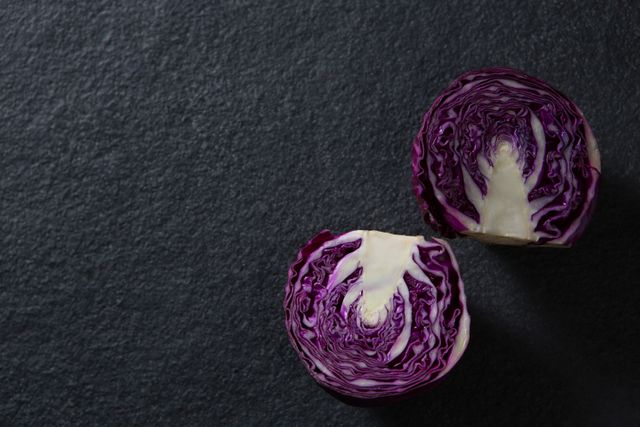 Close-up of halved red cabbage on black background