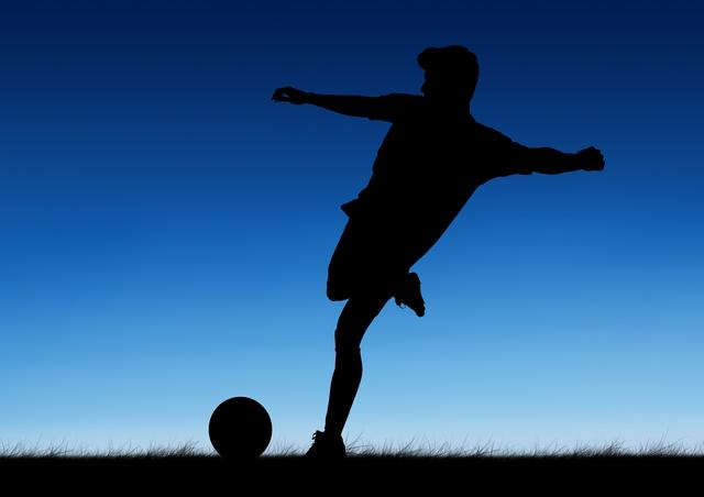 Silhouette of soccer player kicking a ball against blue background