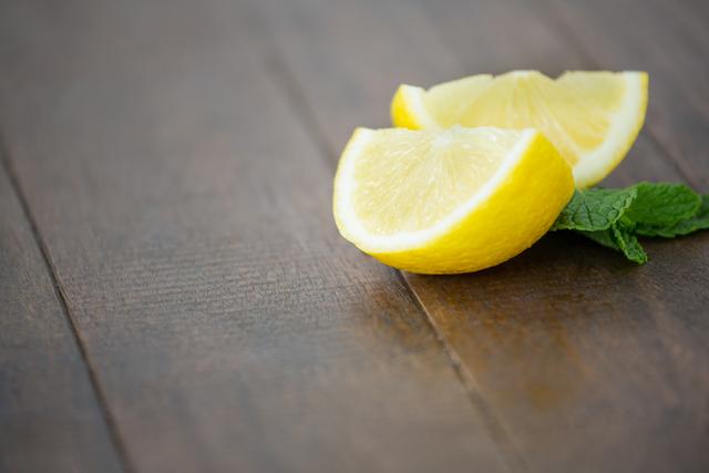 Lemon wedges and mint on wooden board - Download Free Stock Photos Pikwizard.com