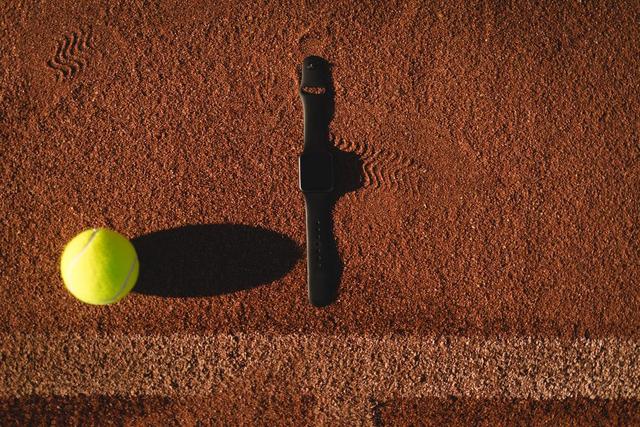 Tennis ball and smartwatch on ground - Download Free Stock Photos Pikwizard.com