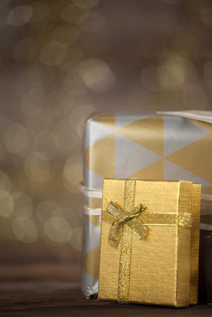 Close-up of wrapped gift boxes on wooden table - Download Free Stock Photos Pikwizard.com